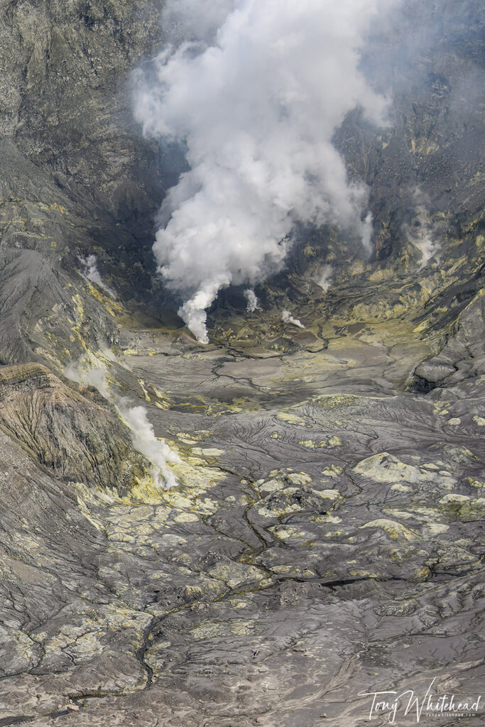 Whakaari/White Island. Looking into the steaming sulphurous crater. Wrecked helicopter bottom centre.